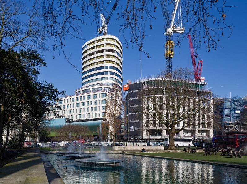 Exclusive high-rise residences with modern architecture, located in a quiet landscaped park with soft evening lighting