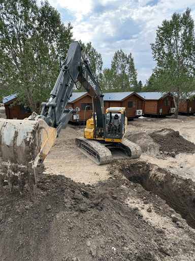 yellow and black excavator on brown brick wall during daytime