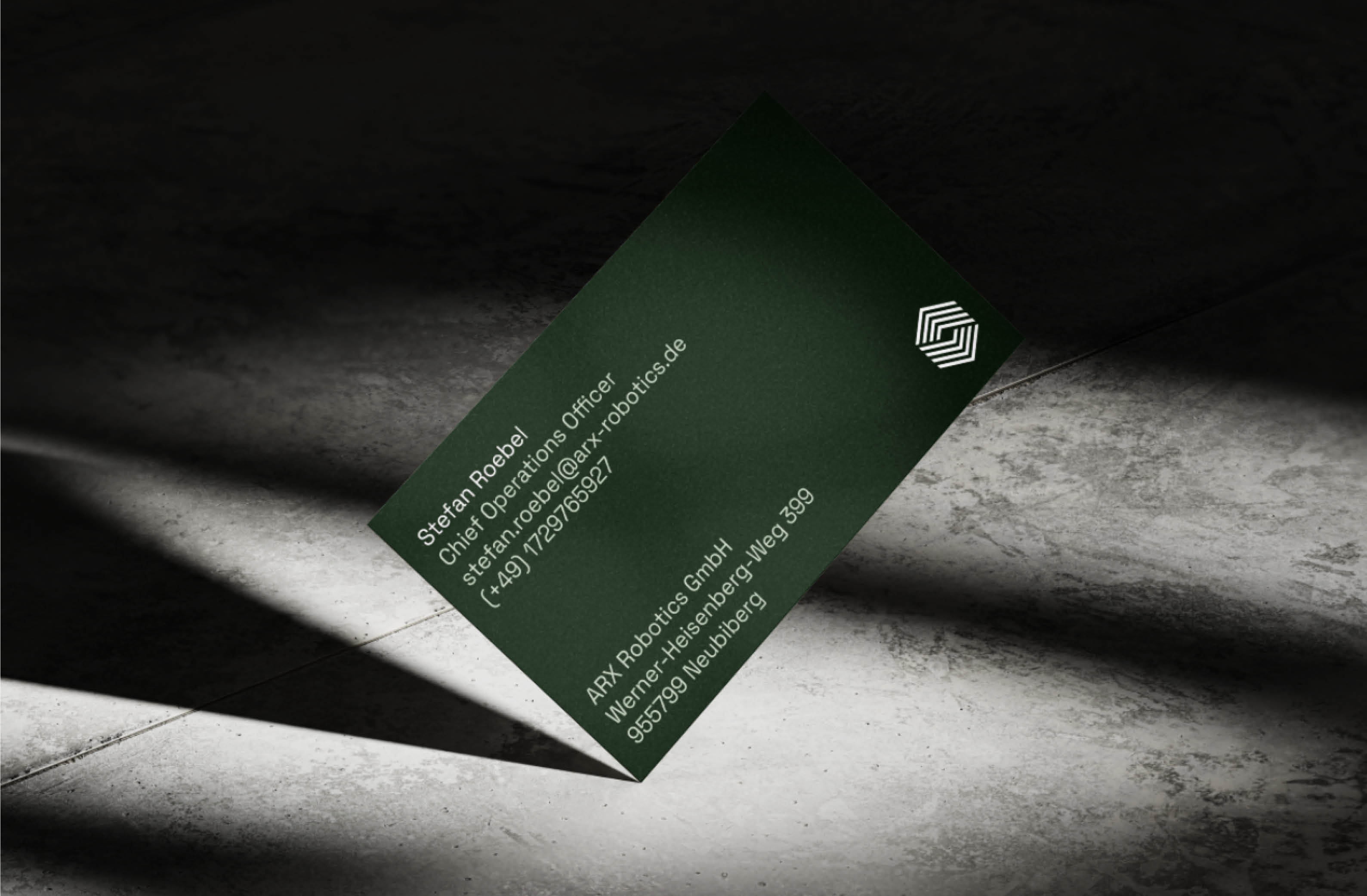 A sophisticated green business card for Stefan Roebel, Chief Operations Officer at ARX Robotics, featuring minimalistic design and contact details.