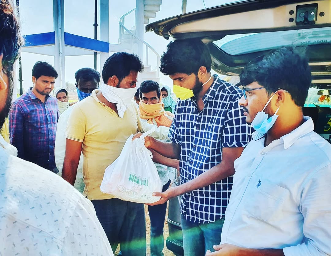 man in black crew neck t-shirt and blue shorts holding woman in white and red