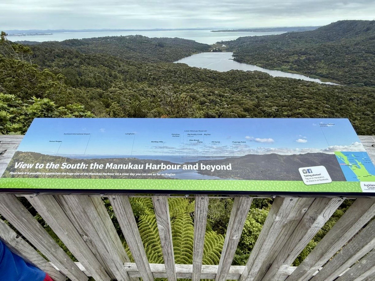 The views of from the viewing deck of Arataki Visitor Centre with rainforests and Tasman sea in the picture