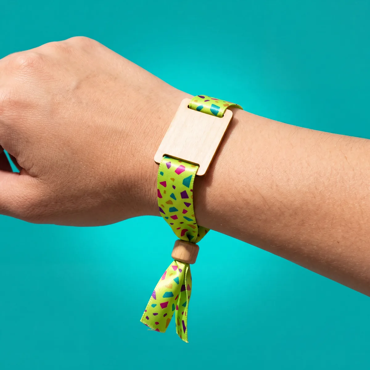 Fabric wristband with wooden plate and bead, worn on the wrist