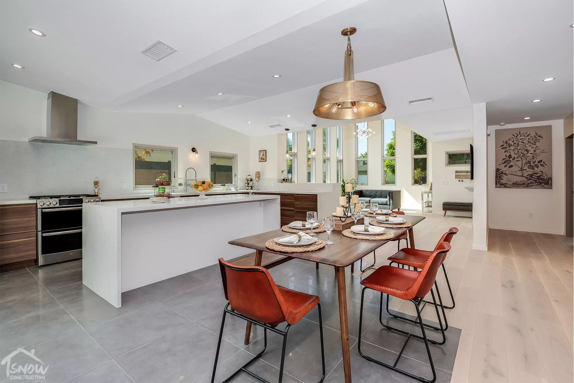 Dining space with wood table, modern kitchen, and natural light