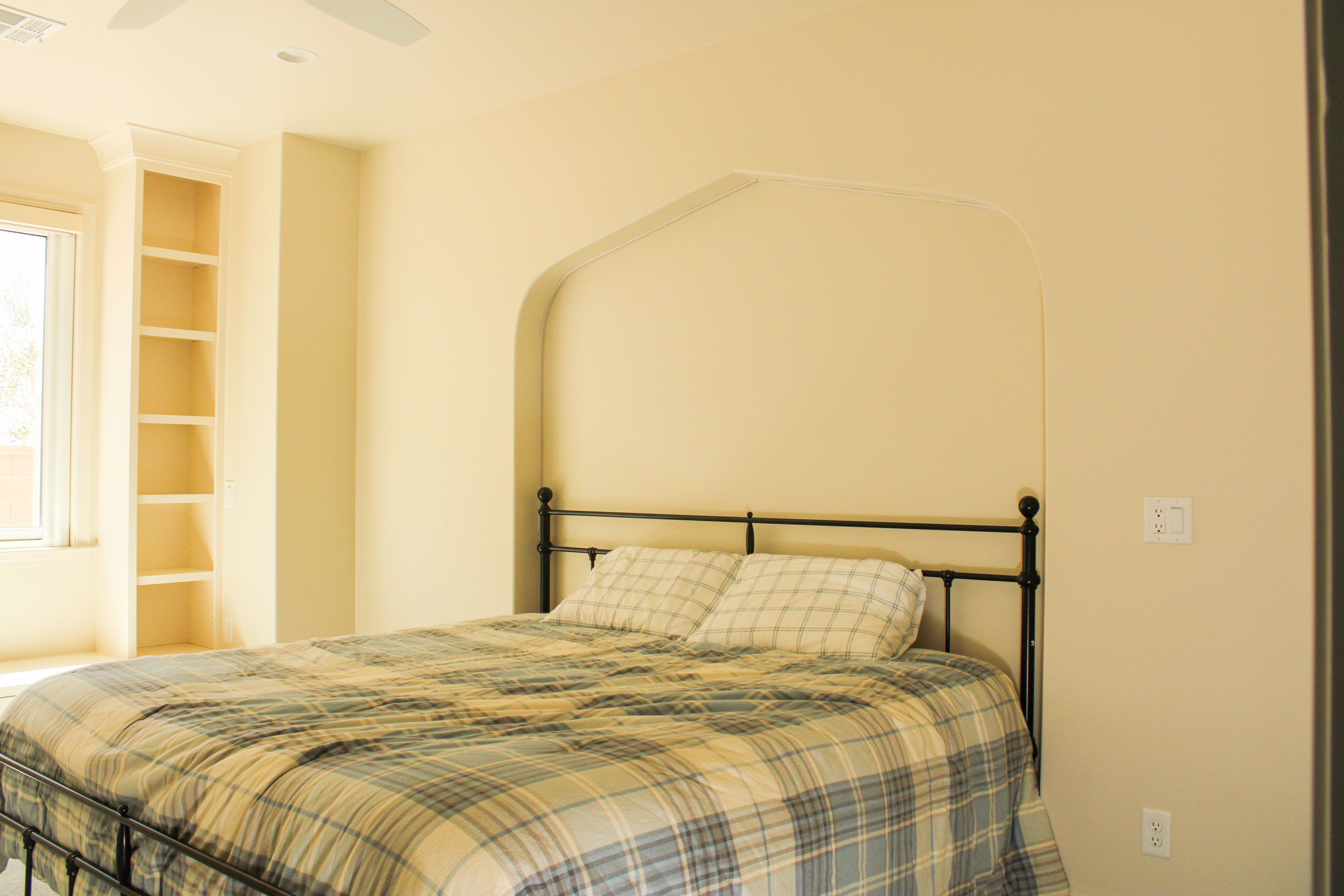 Bedroom with a built-in bench and functional design in a St. George, Utah home.