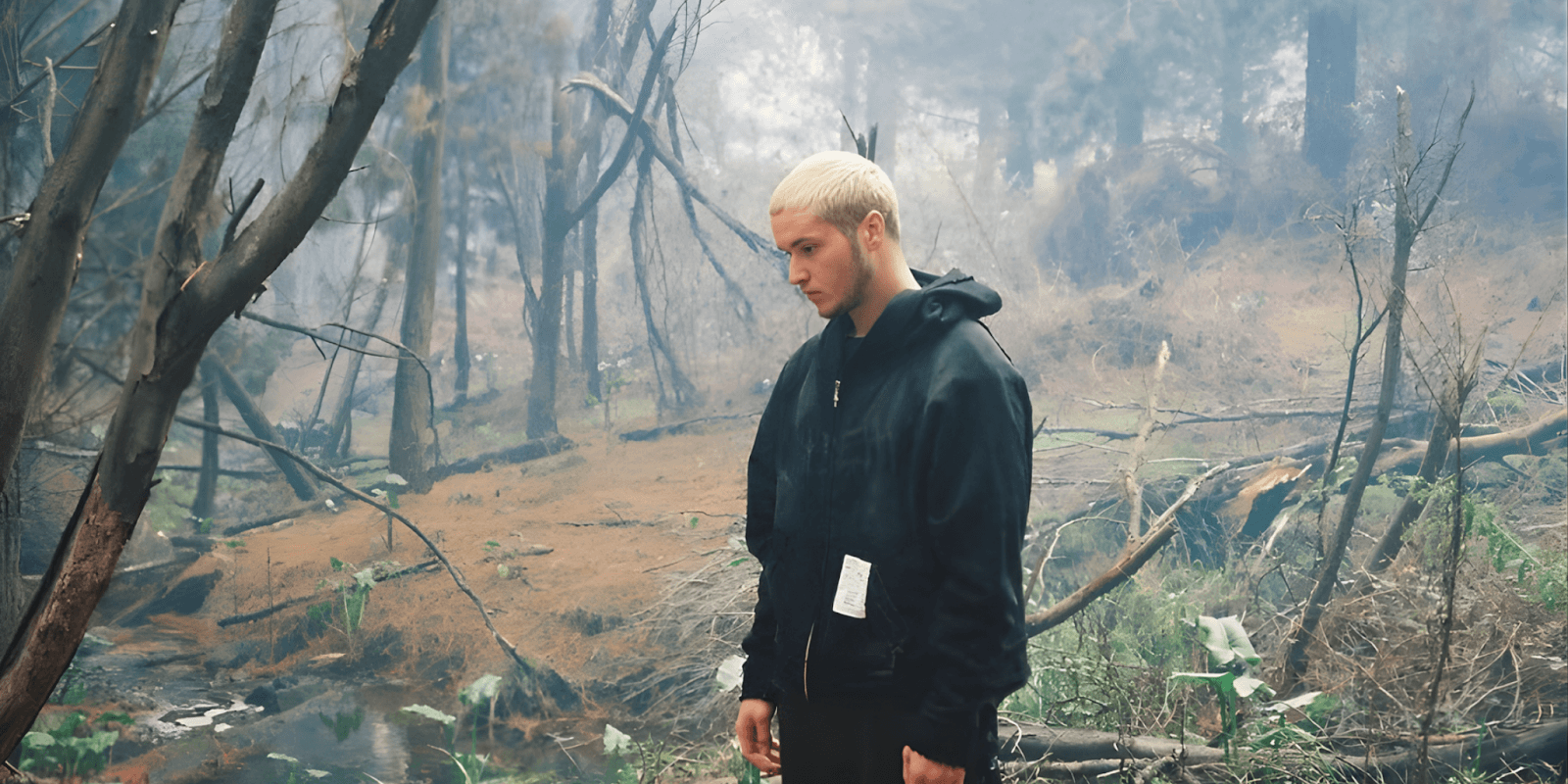 Eduard Luli in a forest, embodying his emotional vulnerability and ambition in melodic rap.