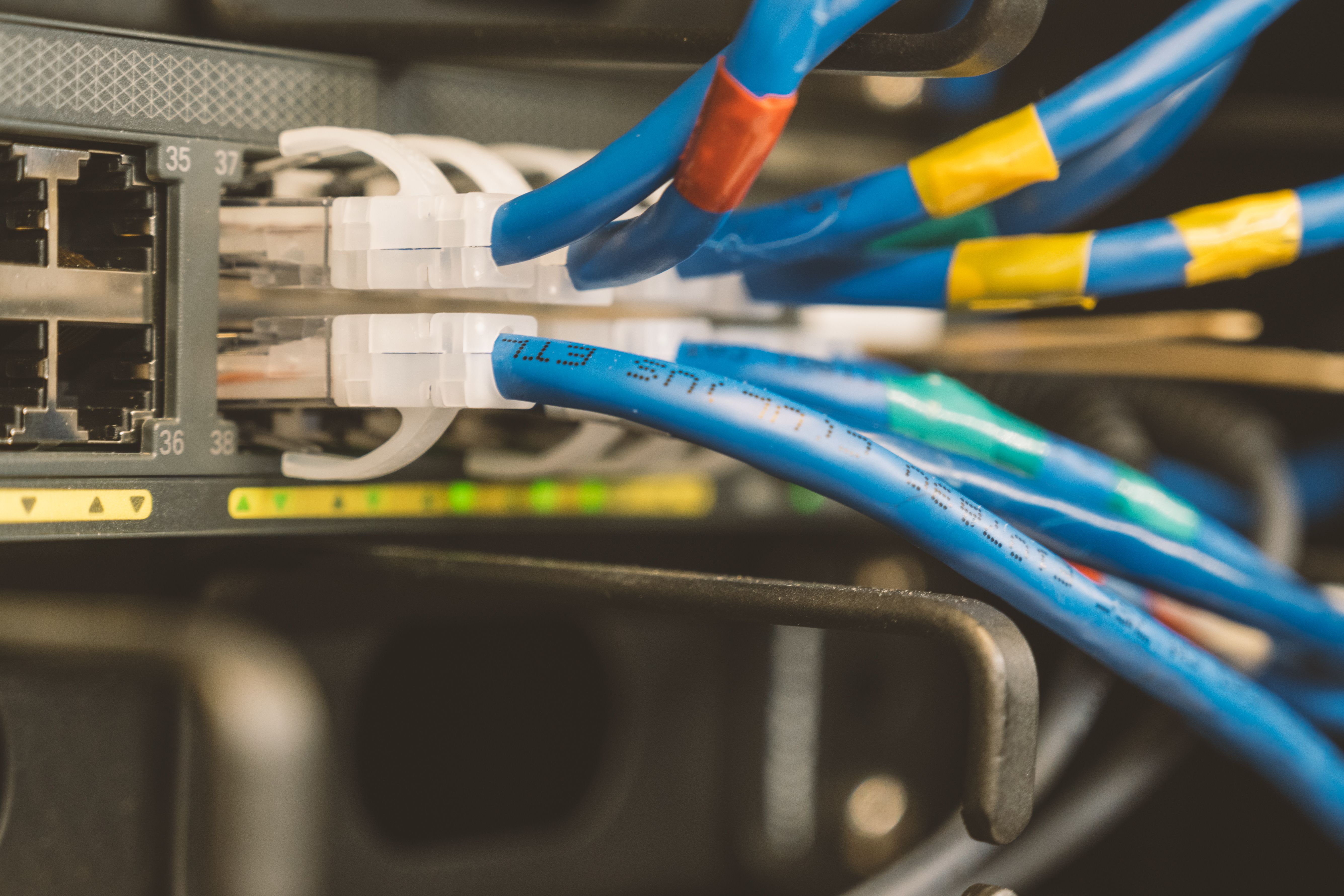 network-switch-and-blue-ethernet-cable-with-white-tips-connected-to-system-for-m - brett-sayles (pexels)