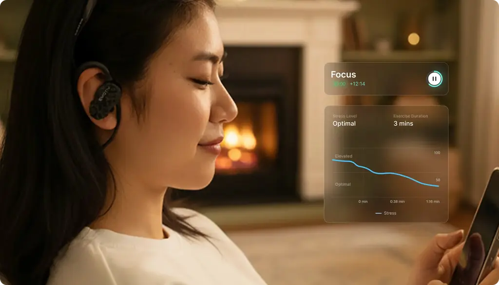 Woman relaxing at home while wearing Emotiv MN8 EEG earbuds and viewing Brainwear cognitive insights on a smartphone. The app displays focus metrics and wellness visualizations designed to support everyday brain awareness and cognitive wellbeing.