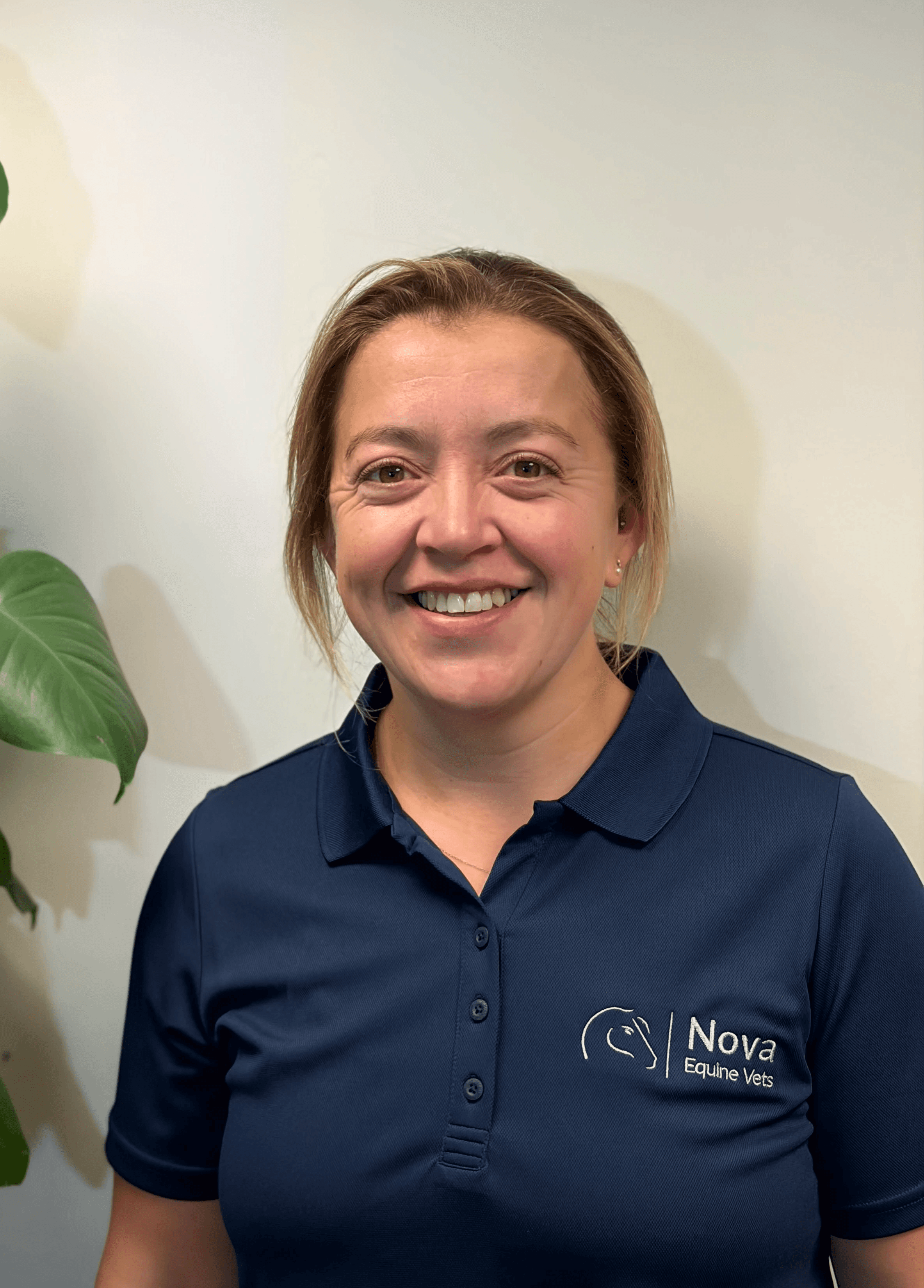 a man in a blue shirt smiling at the camera