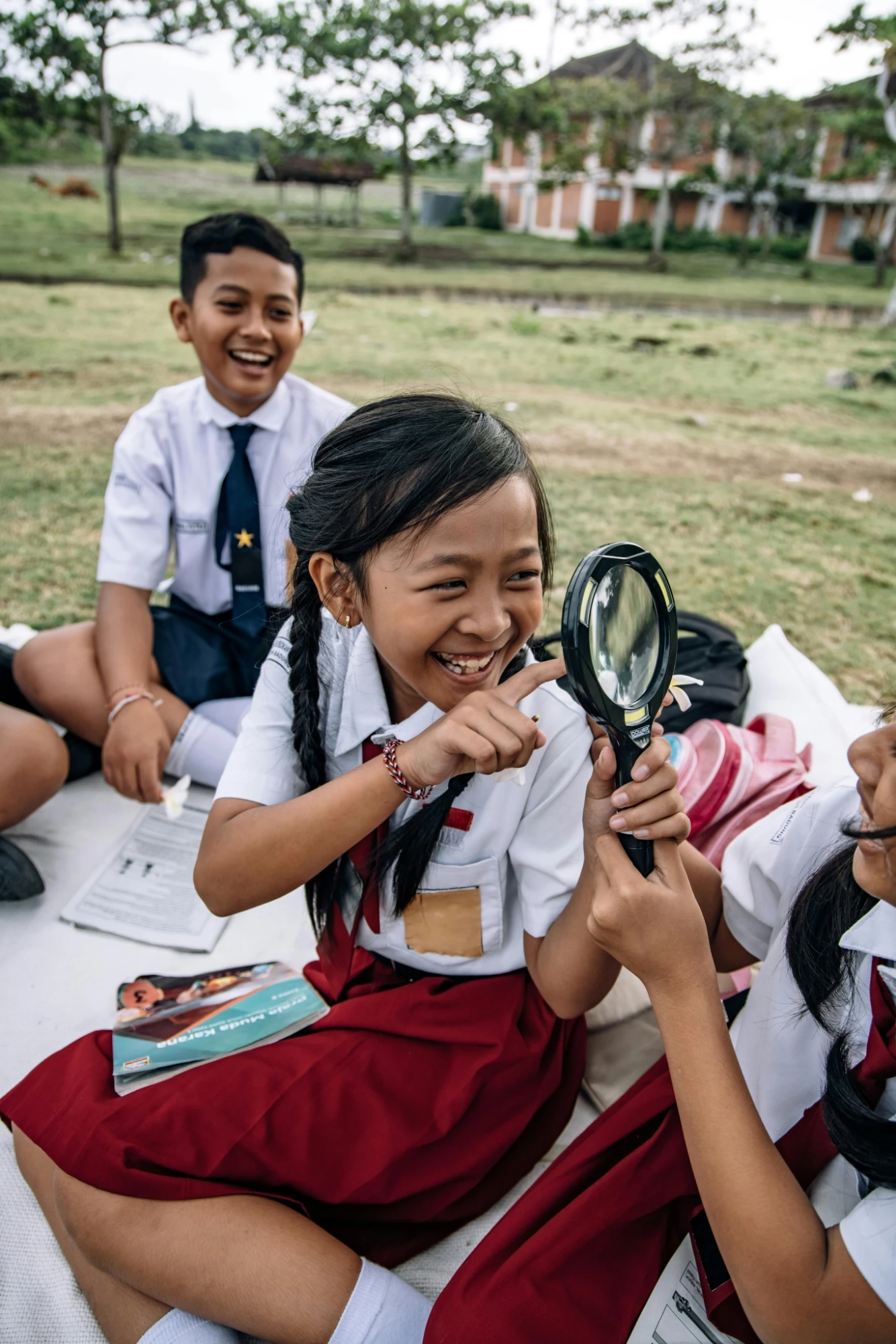 kids laughing with magnifying glass