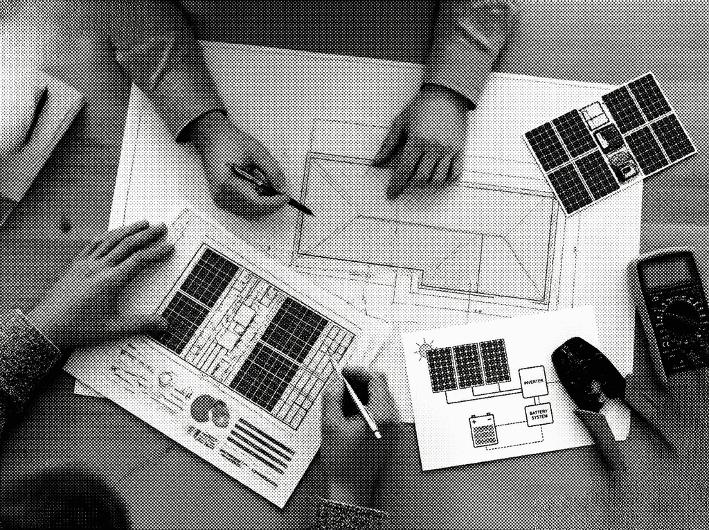 Solar engineers planning a residential solar panel installation layout