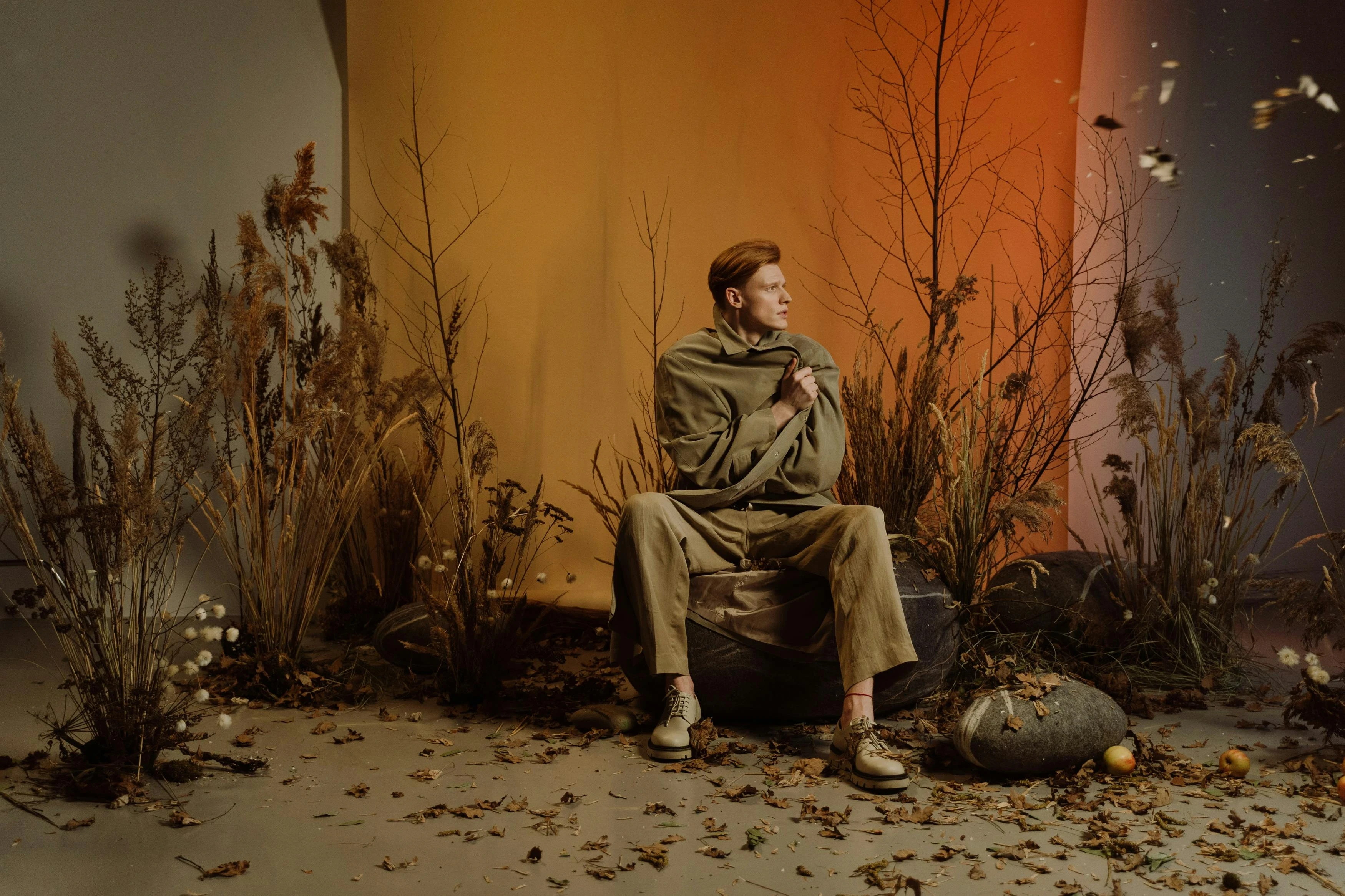 Ethan Harper sitting with scarf and pose