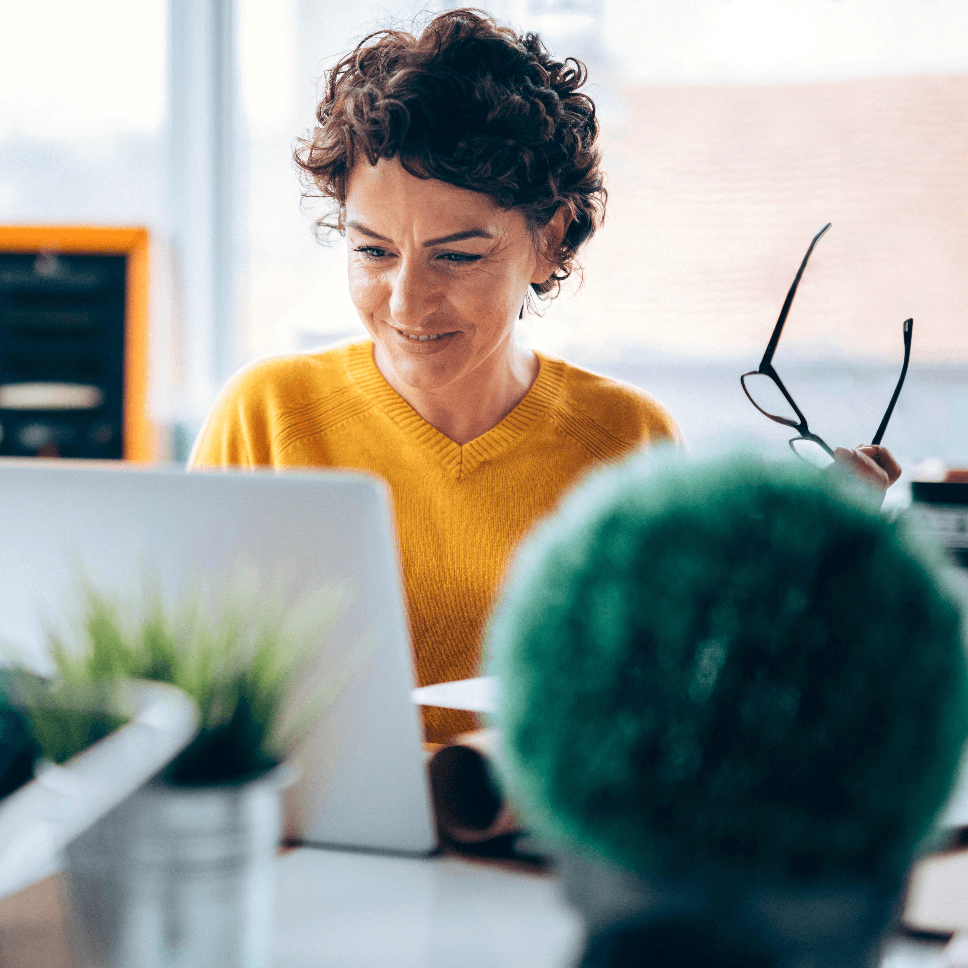 Woman working in ticketing looking at laptop