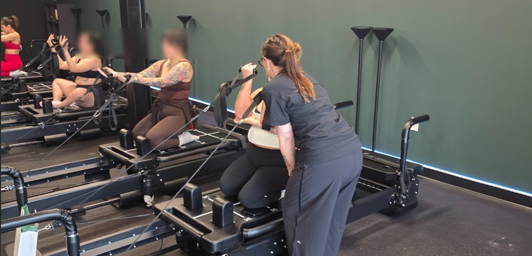 Instructor correcting form at sculptme Fort Worth