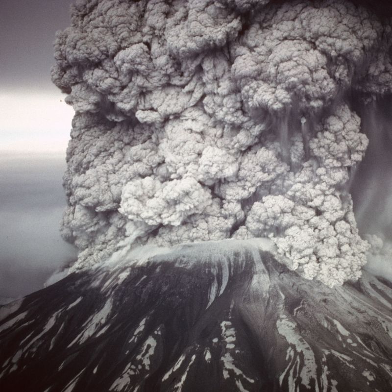Massive ash plume erupting violently from Mount St. Helens, with dense clouds of ash and volcanic material billowing high above the crater.