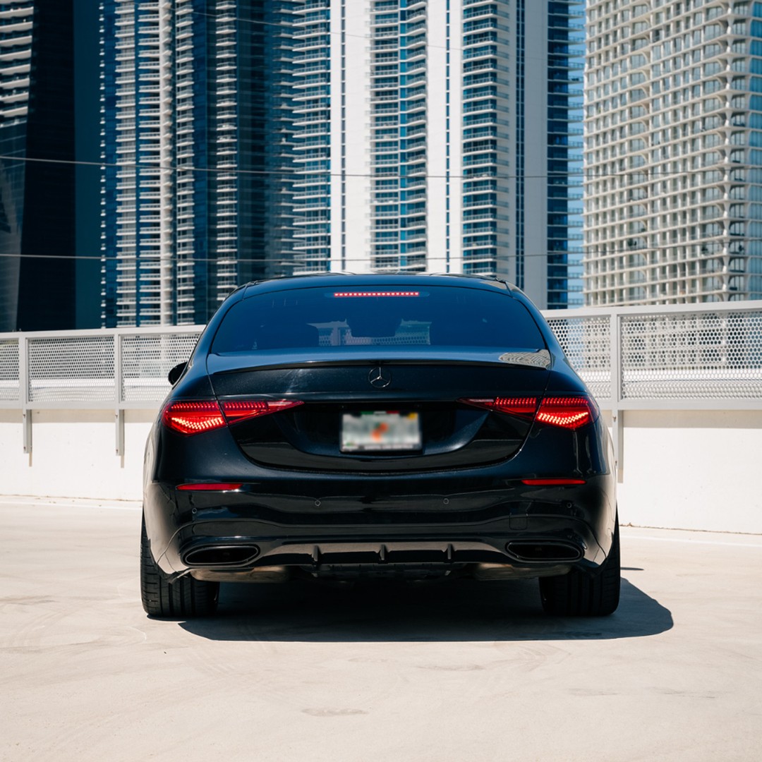 Rear view of a black Mercedes-Benz S 580, highlighting its sophisticated taillights and executive presence.