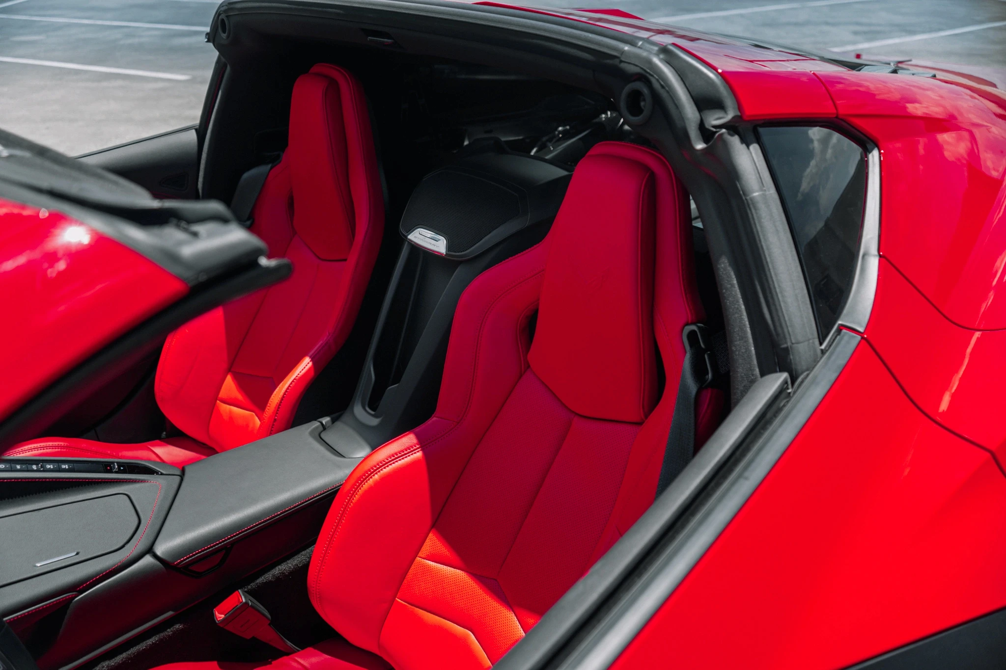 Two cheerful men laughing in the front seats of a sportscar, great for car rental joy promotions.