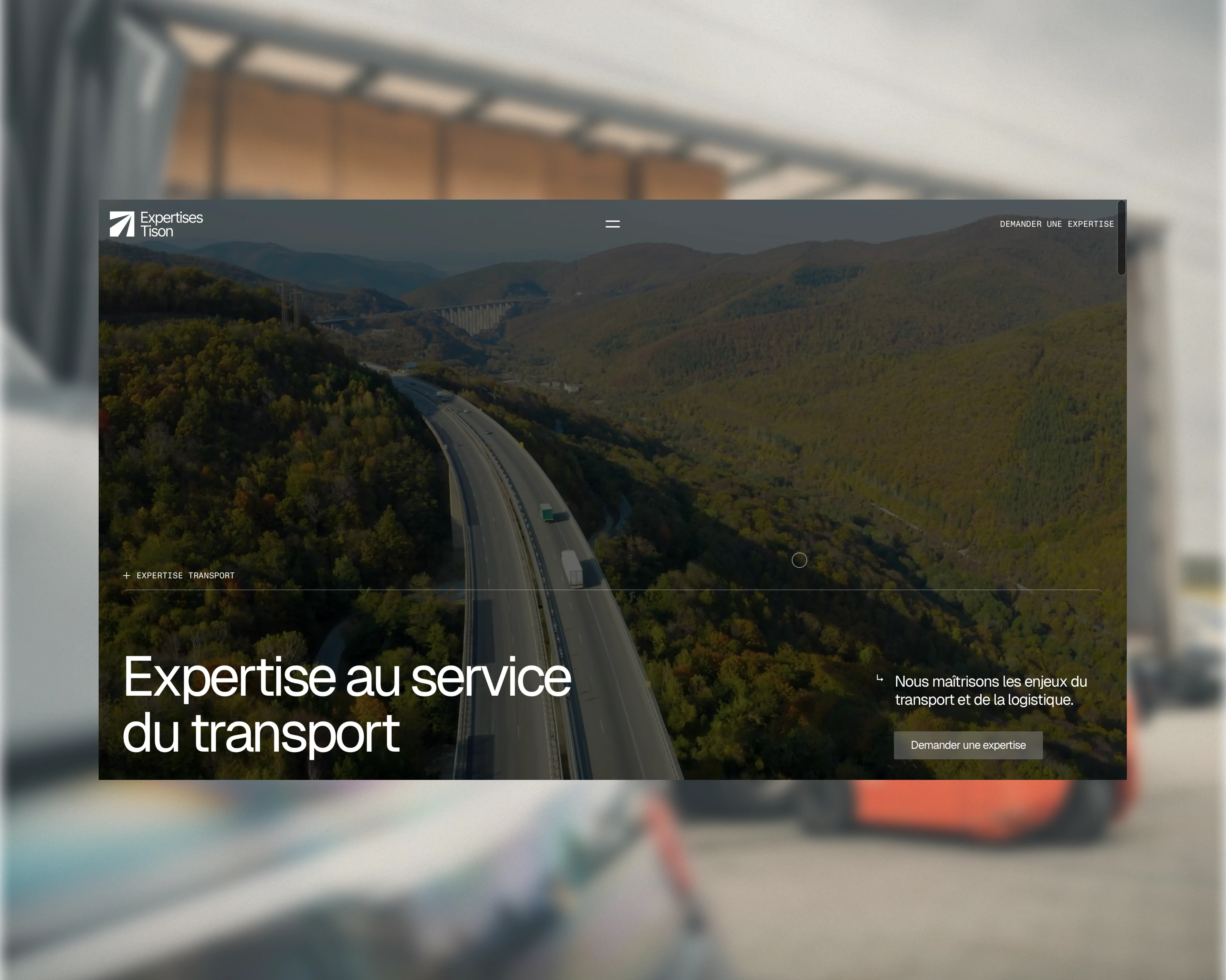 Smiling man working on a laptop at a desk, seated in front of a colorful abstract painting