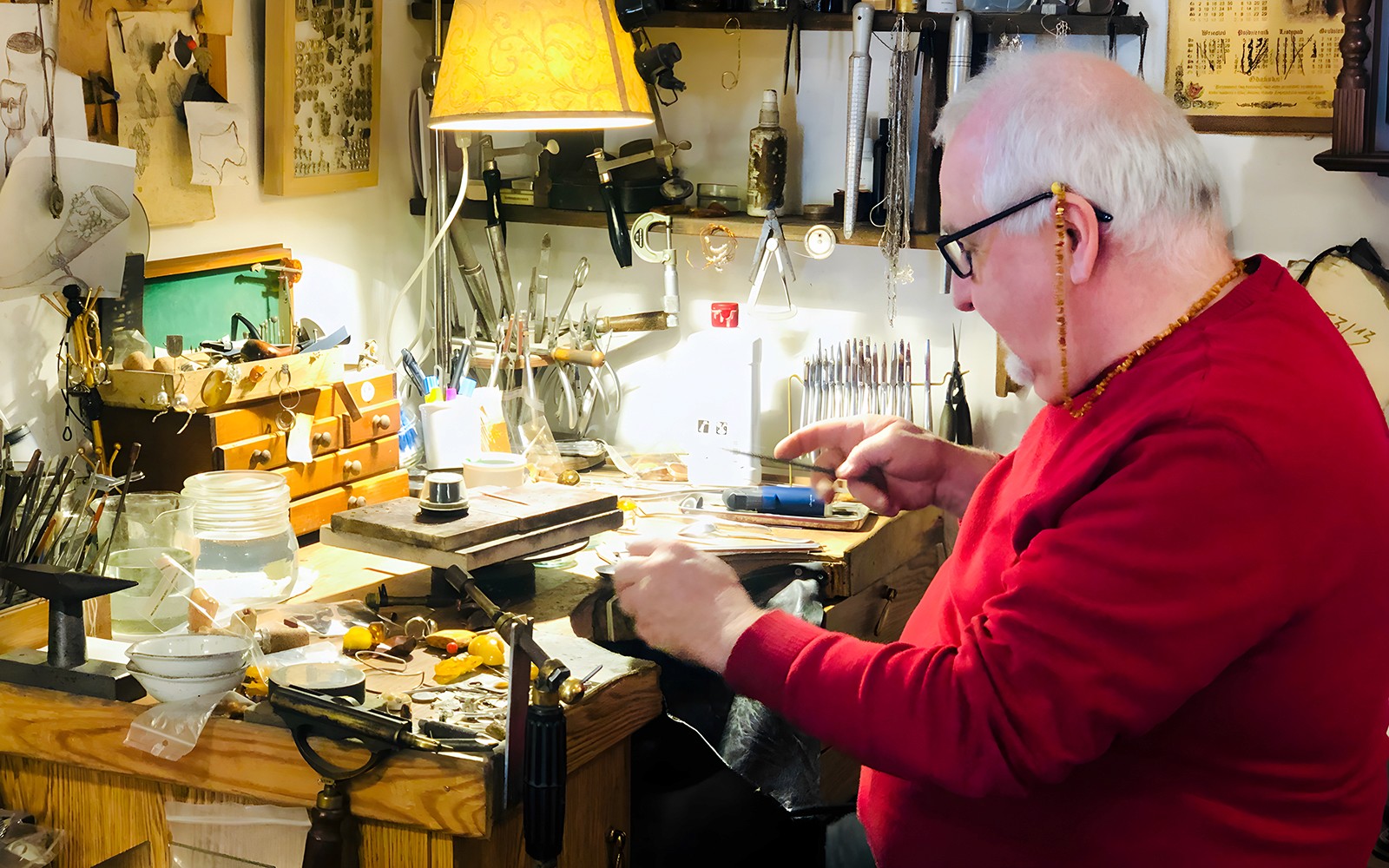 Craftsman working on amber jewelry at a workshop in Gdańsk.