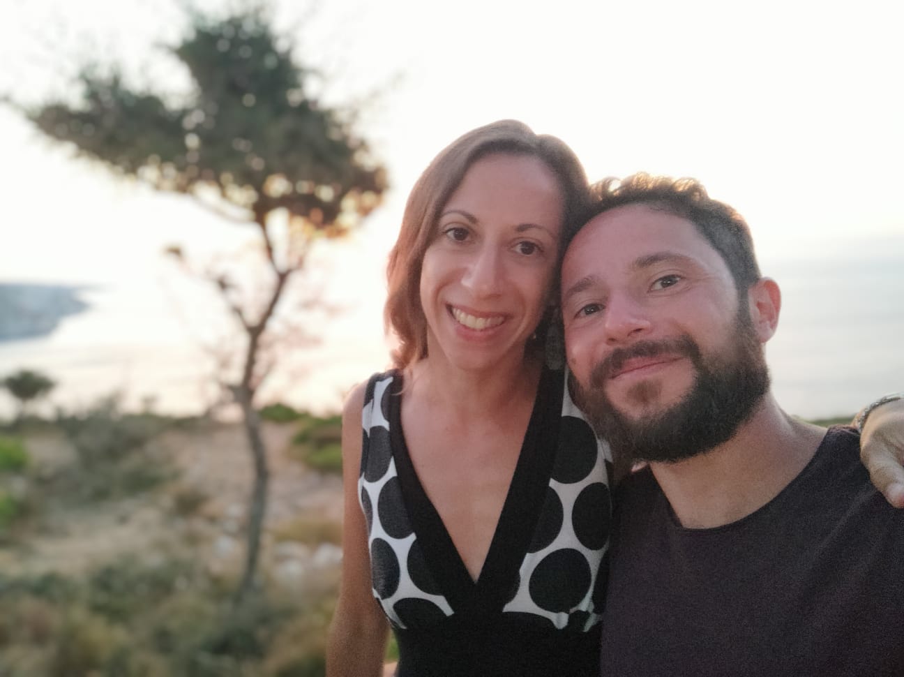 A woman in a baseball cap, blue sky in the background.