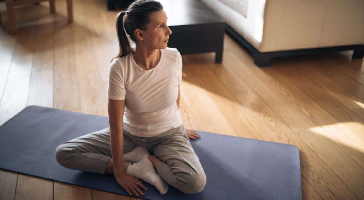 A mature woman does yoga.