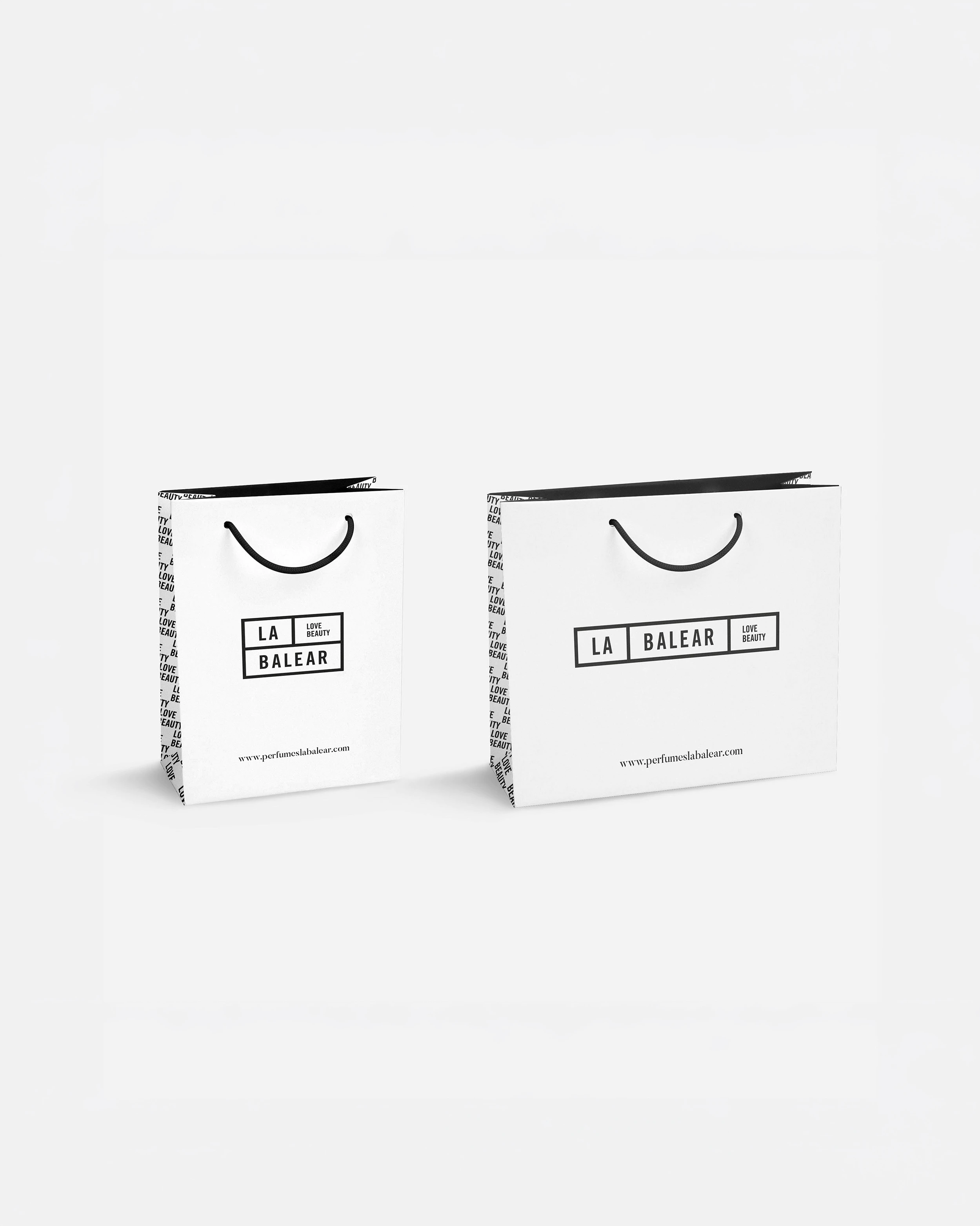 Two white La Balear paper shopping bags, brand identity design by Sebastian Saavedra