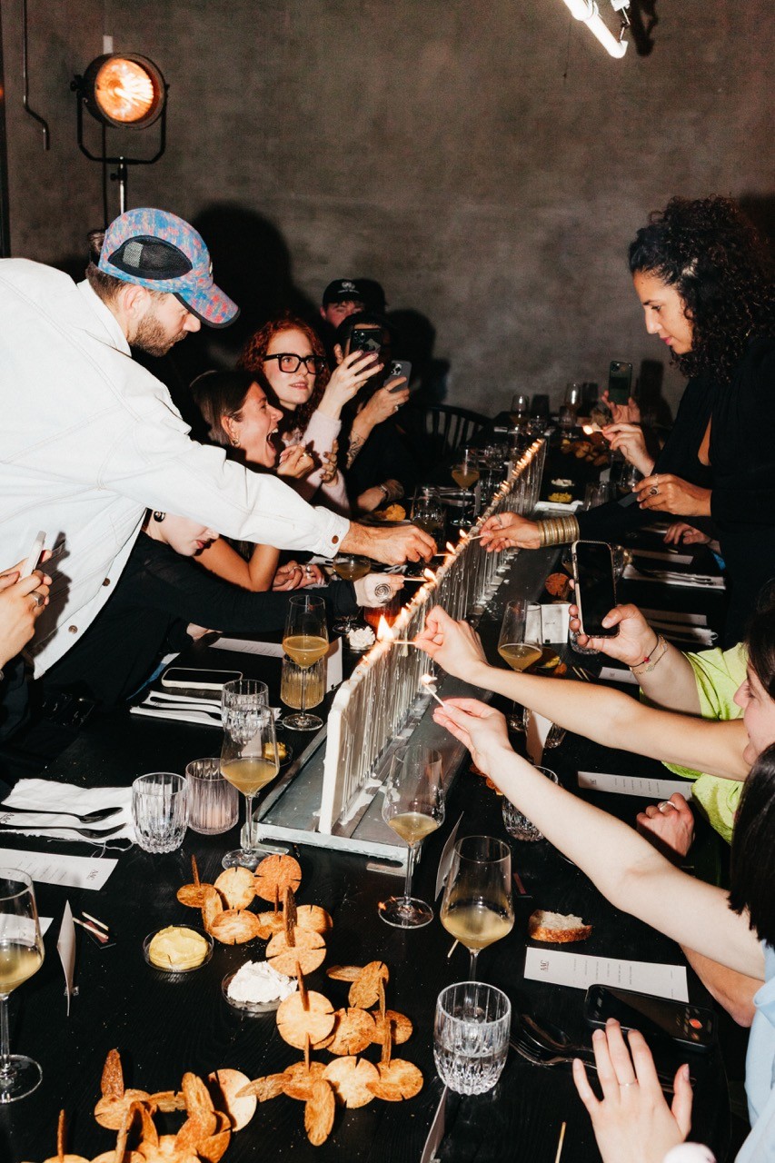 A close-up of a beige-colored laptop with a smooth, matte finish on a matching surface.