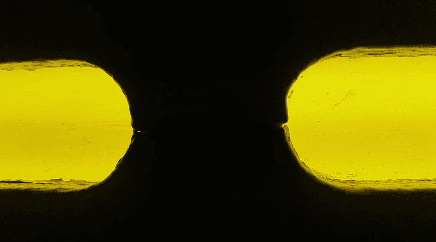 Abstract black shapes against a bright yellow background.