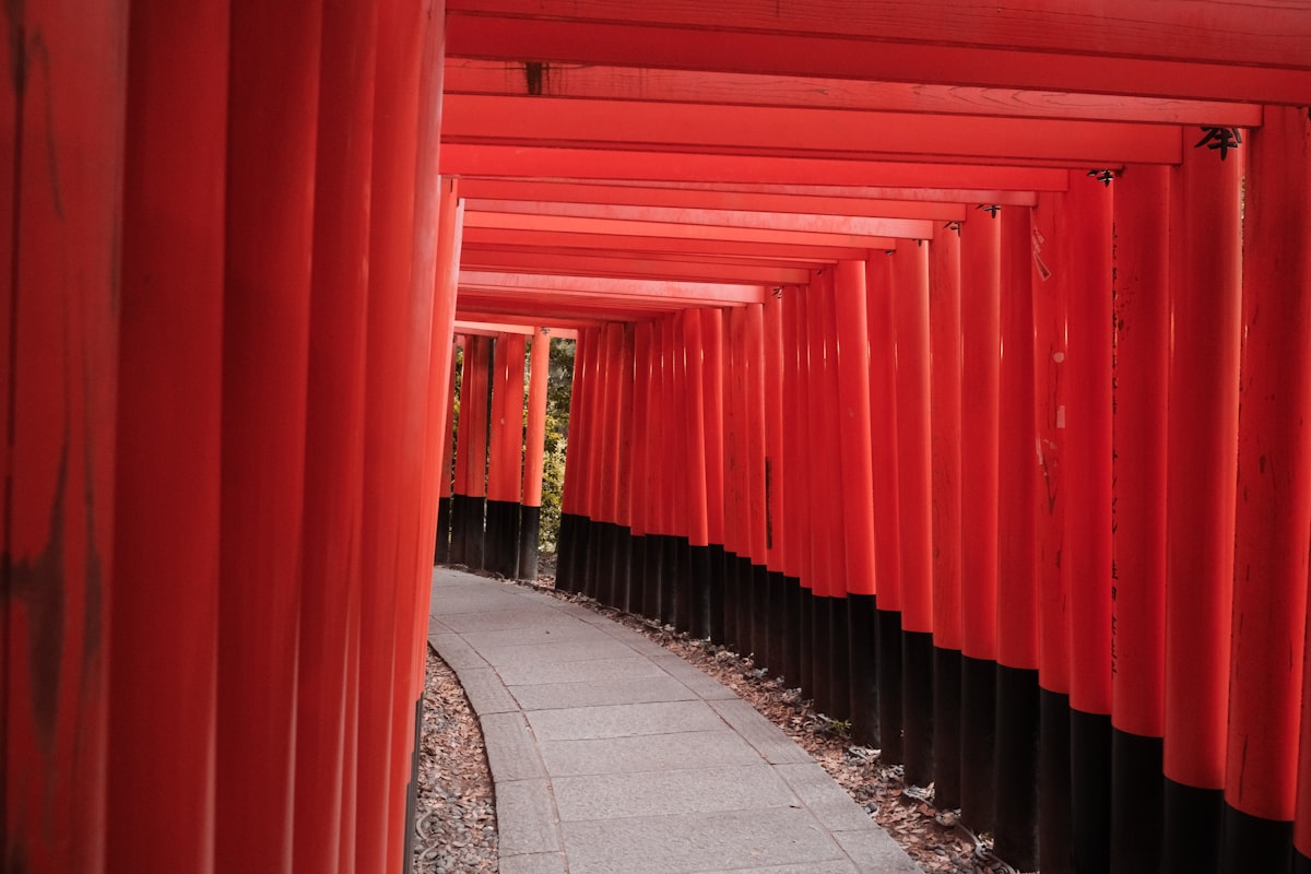 Trail of thousands of vermillion torii gates winding up the hillside at Fushimi Inari Shrine in Kyoto