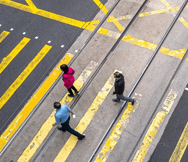 People walking across a crosswalk supporting content about pedestrian injury claims in Stockton