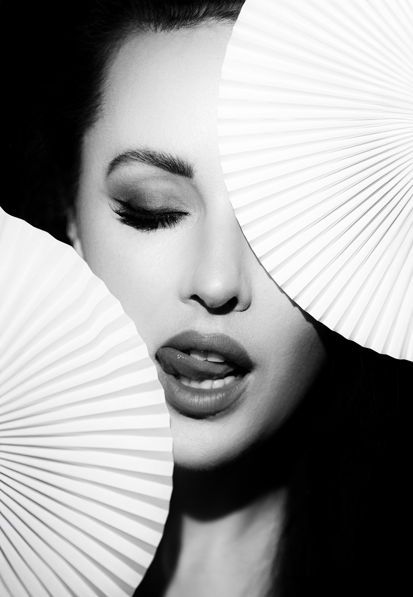 Woman partially hidden behind large white fan, light and shadow play, black and white fine art — The Fan series by Agnieszka Czyzkowska