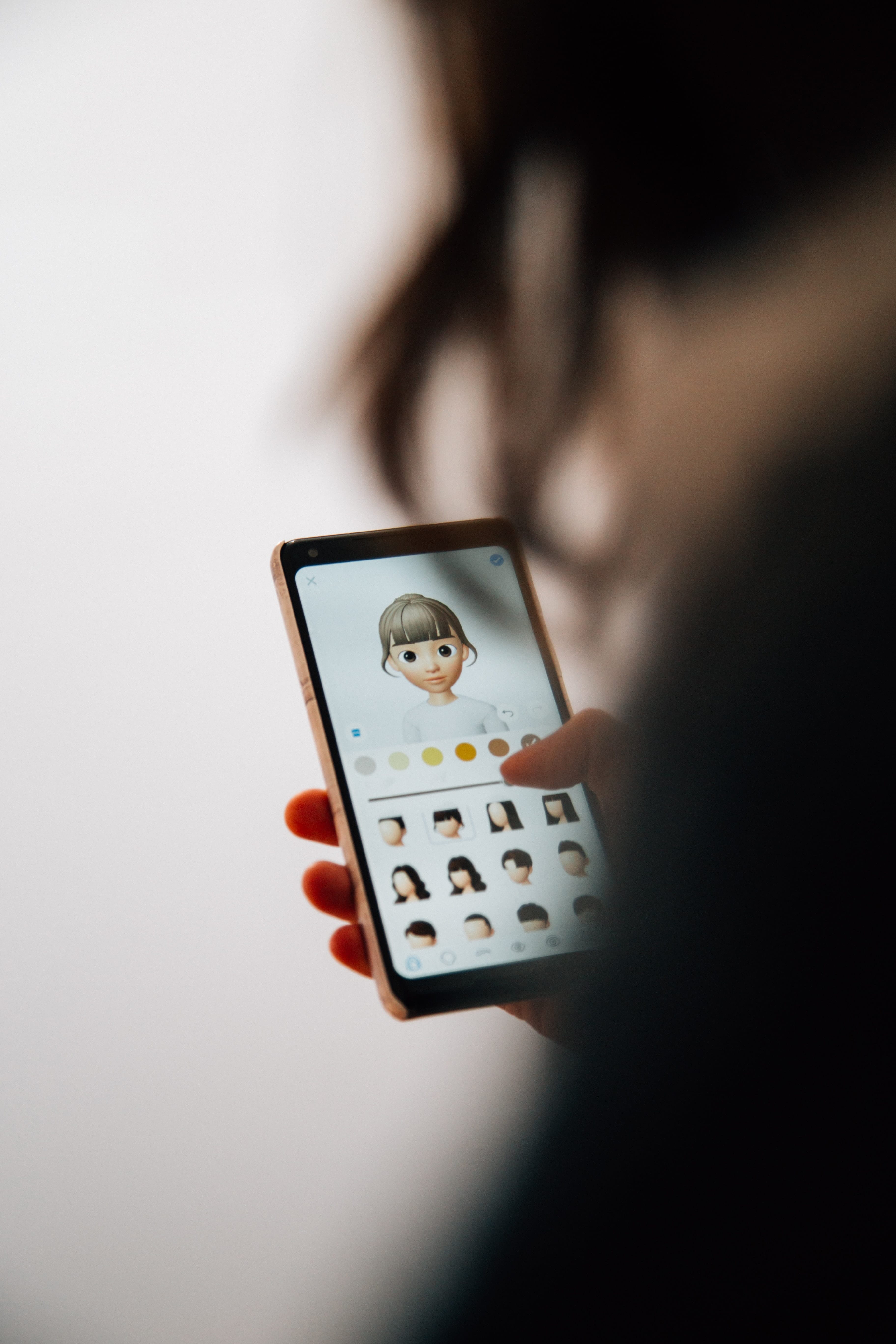 Close up of a mobile phone with memojis