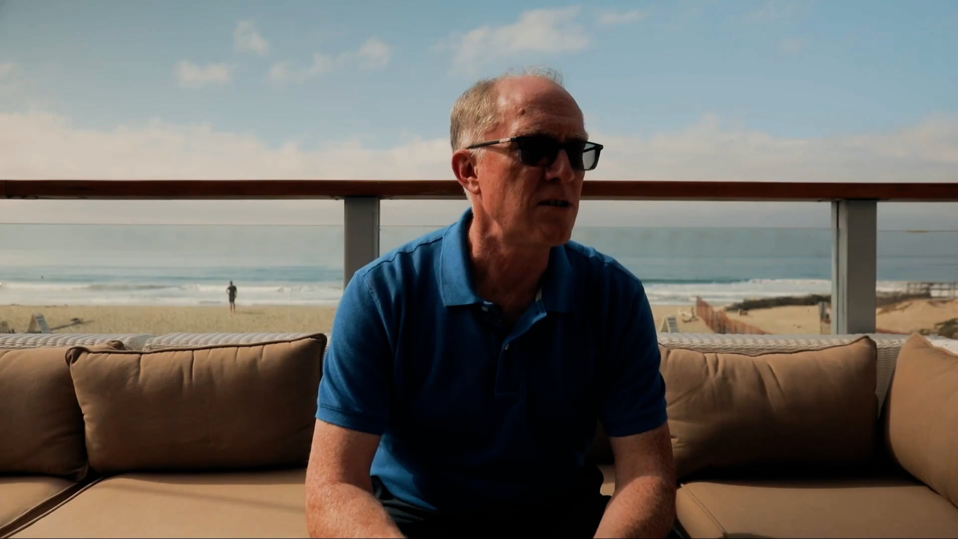 Trend Micro Director of Customer Success, Tracy Shouldice, sitting on a sofa in front of the beach in Malibu.