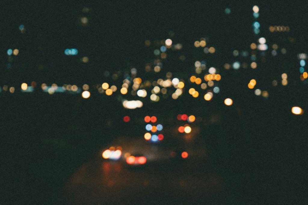 Blurred city lights and car trails at night