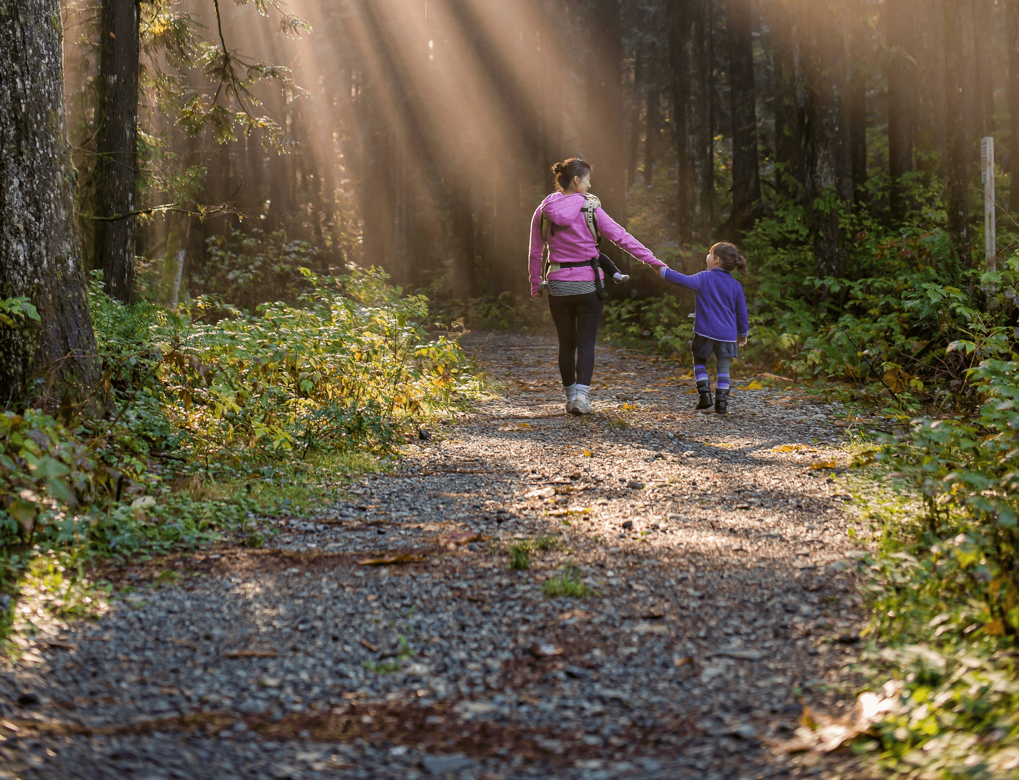 woman walking in forest with child