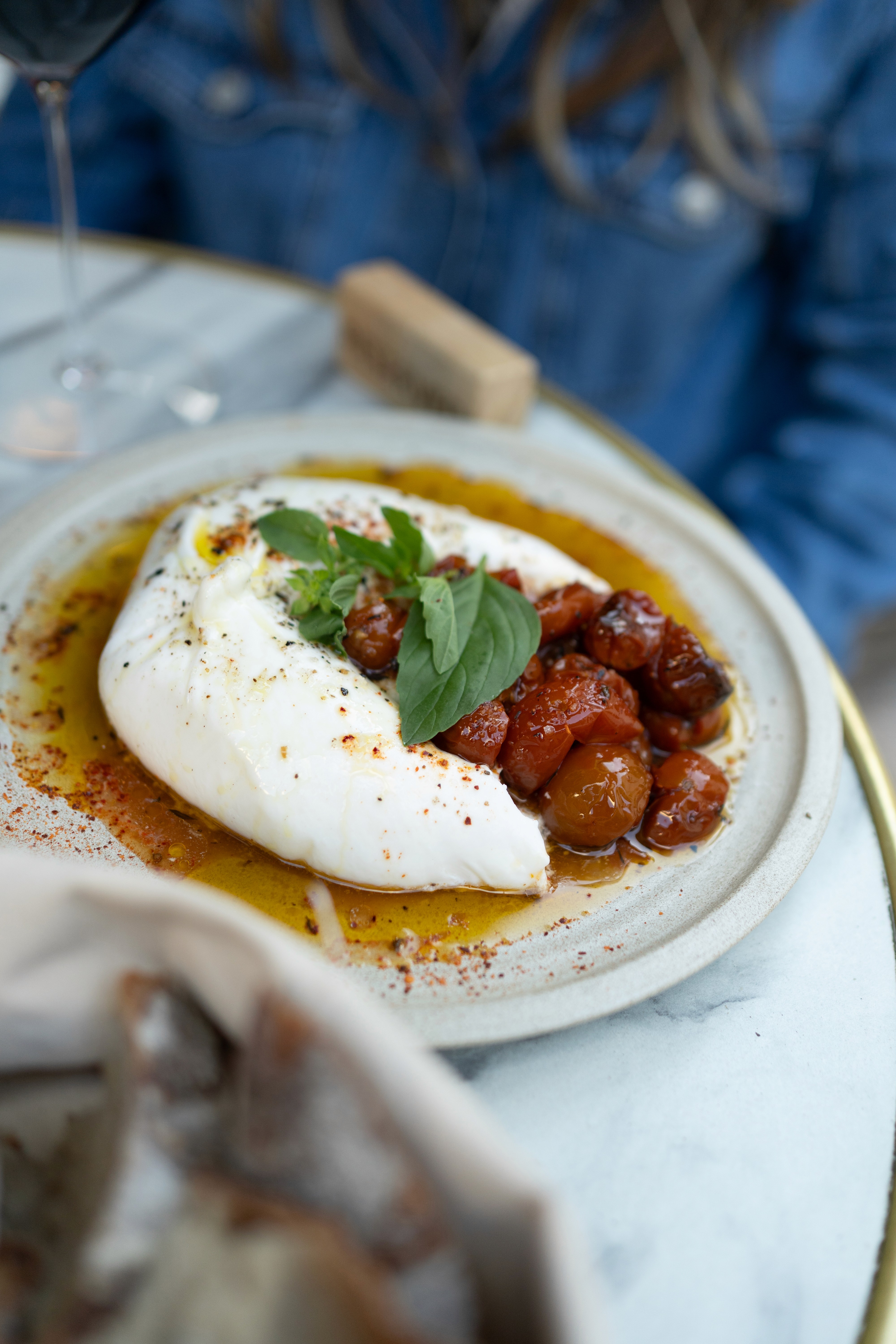 A close-up of a bunch of ripe red grapes hanging from a vine.