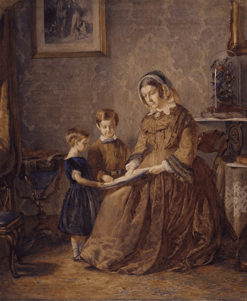A woman and a child sit together in a cozy room, sharing a moment of connection and tenderness.