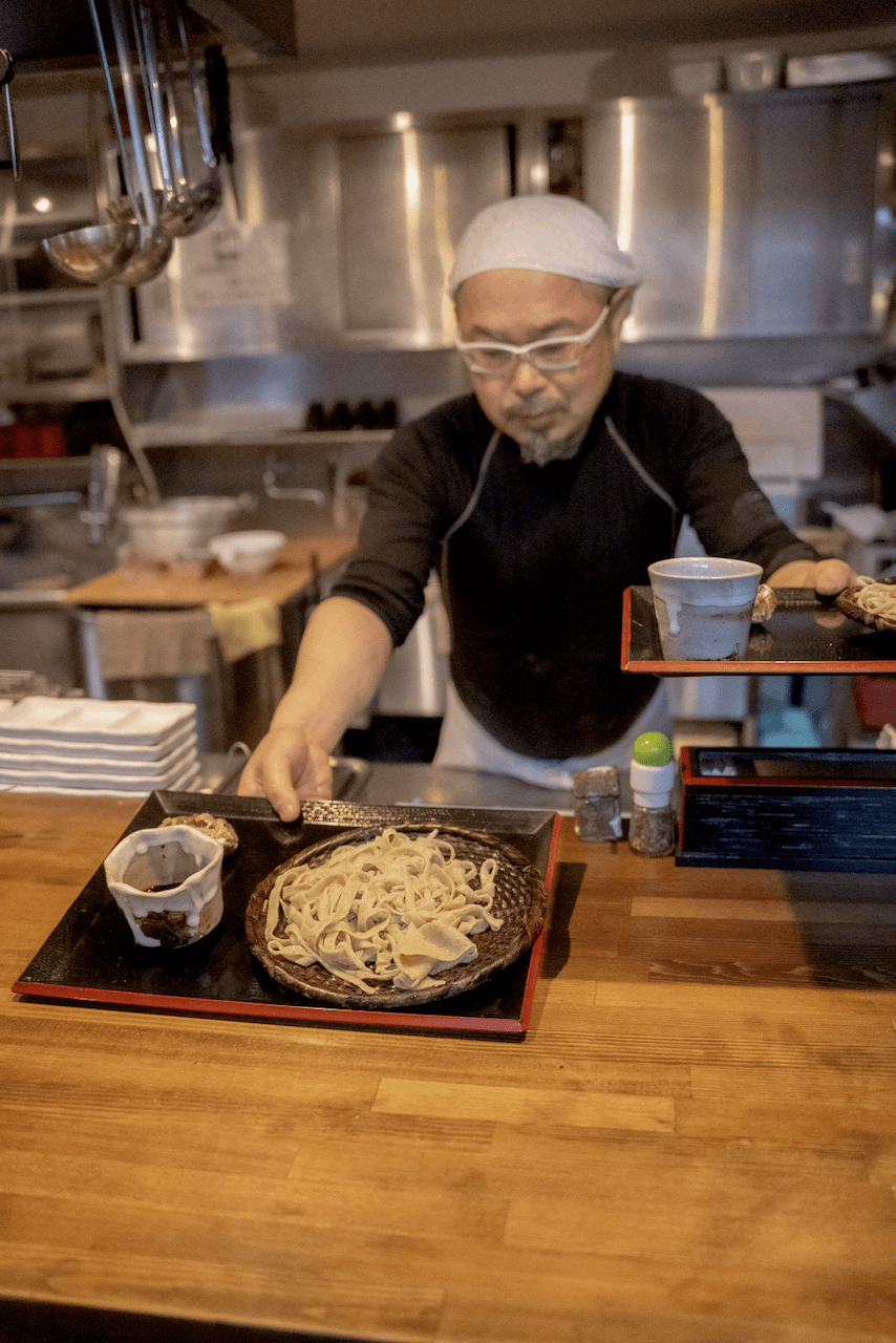 Chef serving soba noodles