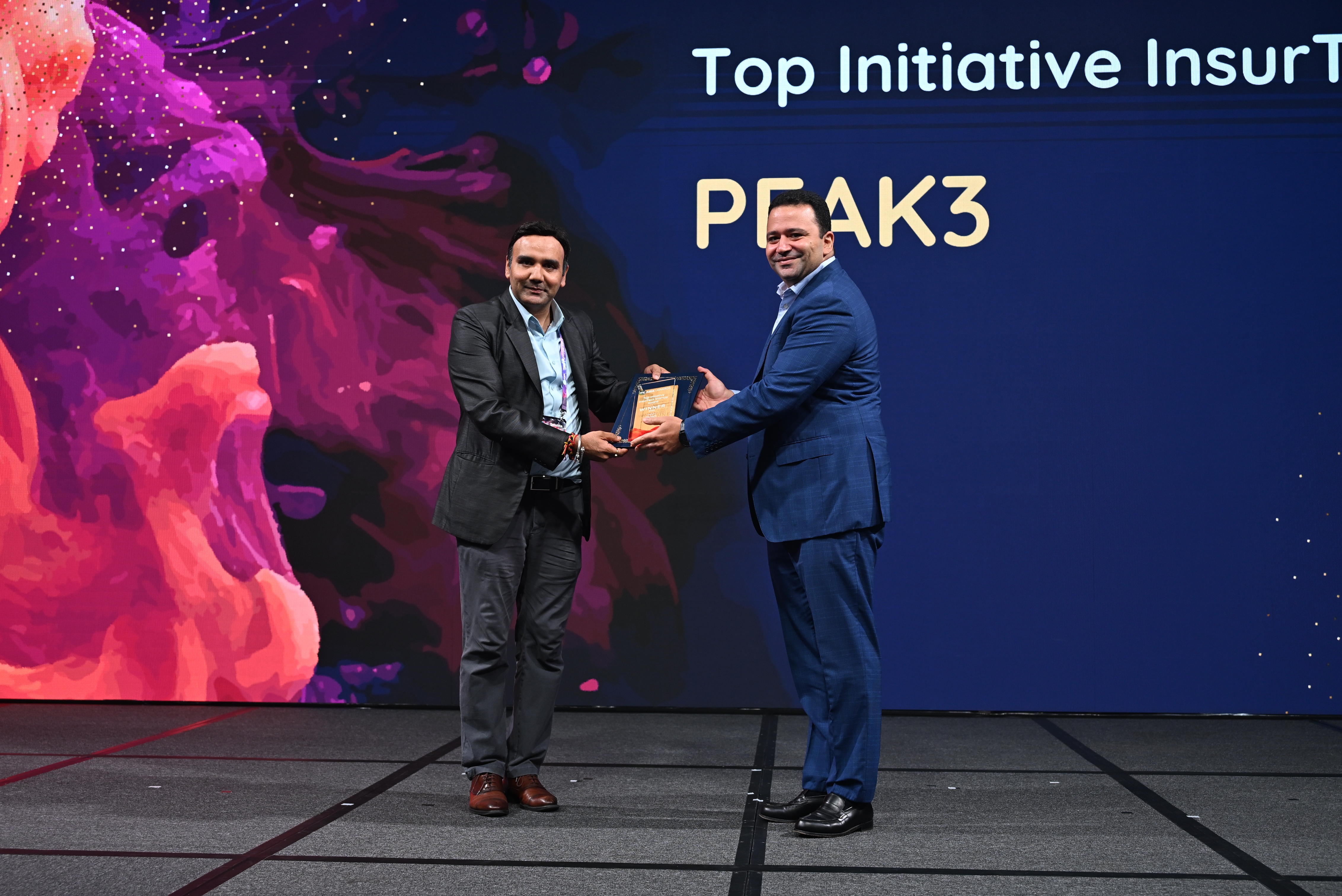 Peak3 wins top insurtech award blog post iamge showing someone from Peak3 accepting an award on a stage. 