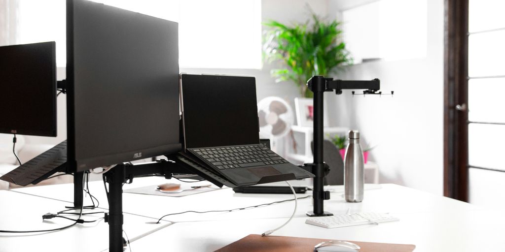 laptop, monitor, and vacuum flask on white table