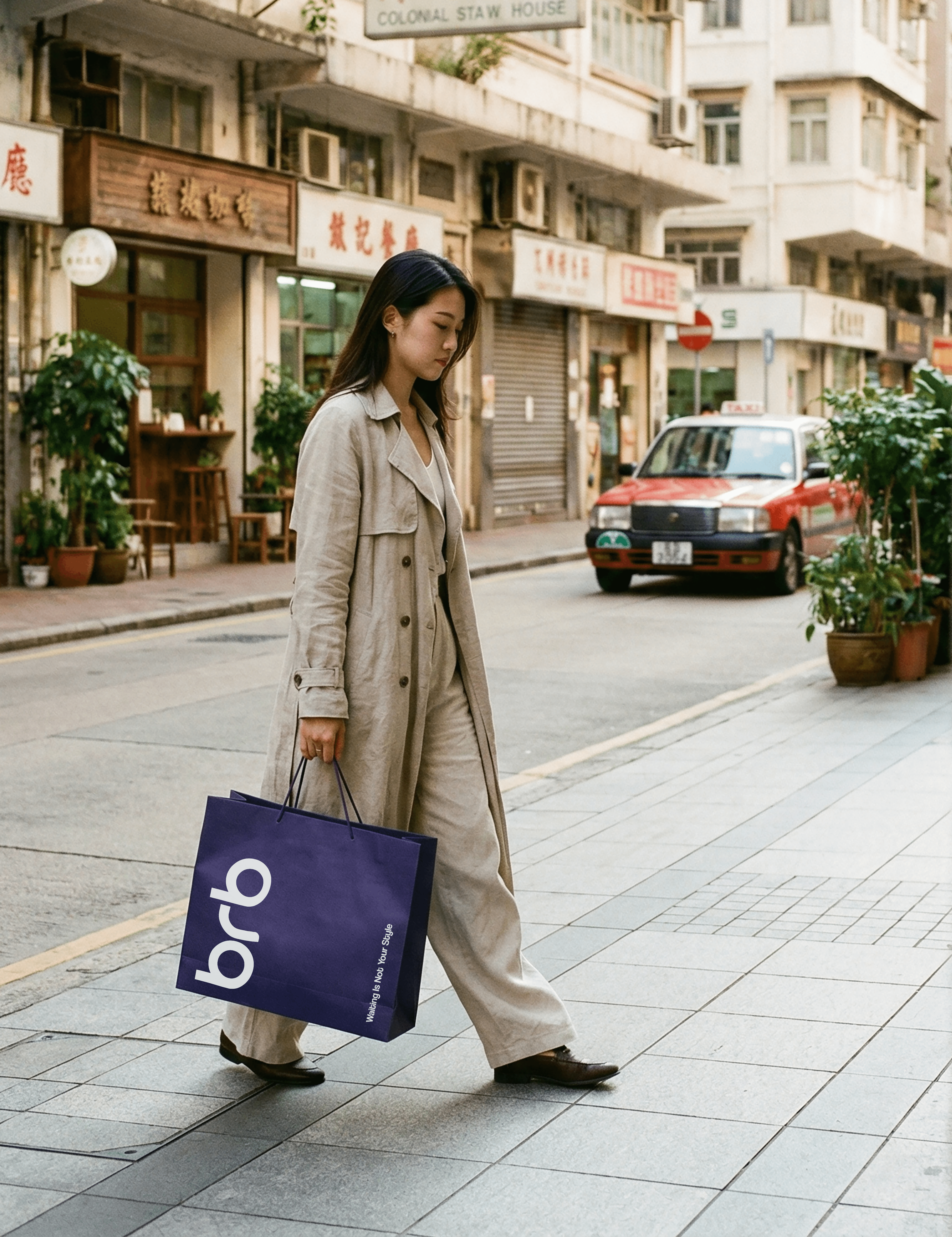 Hong Kong woman looking in the mirror holding a BRB shopping bag after receiving a delivery