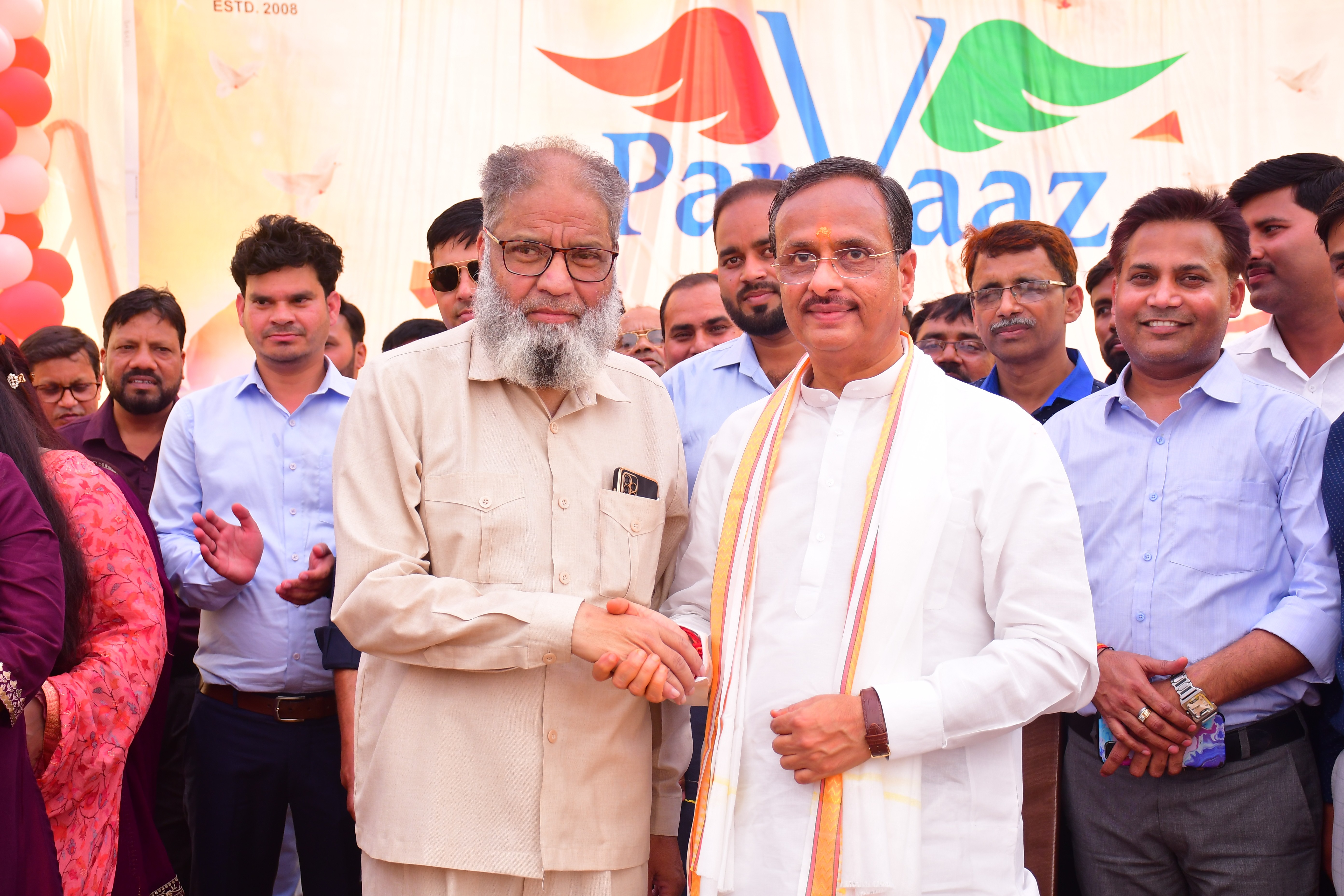 man standing in front of people sitting beside table with laptop computers