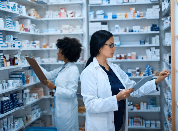 image iof two female chemists looking at persriptions
