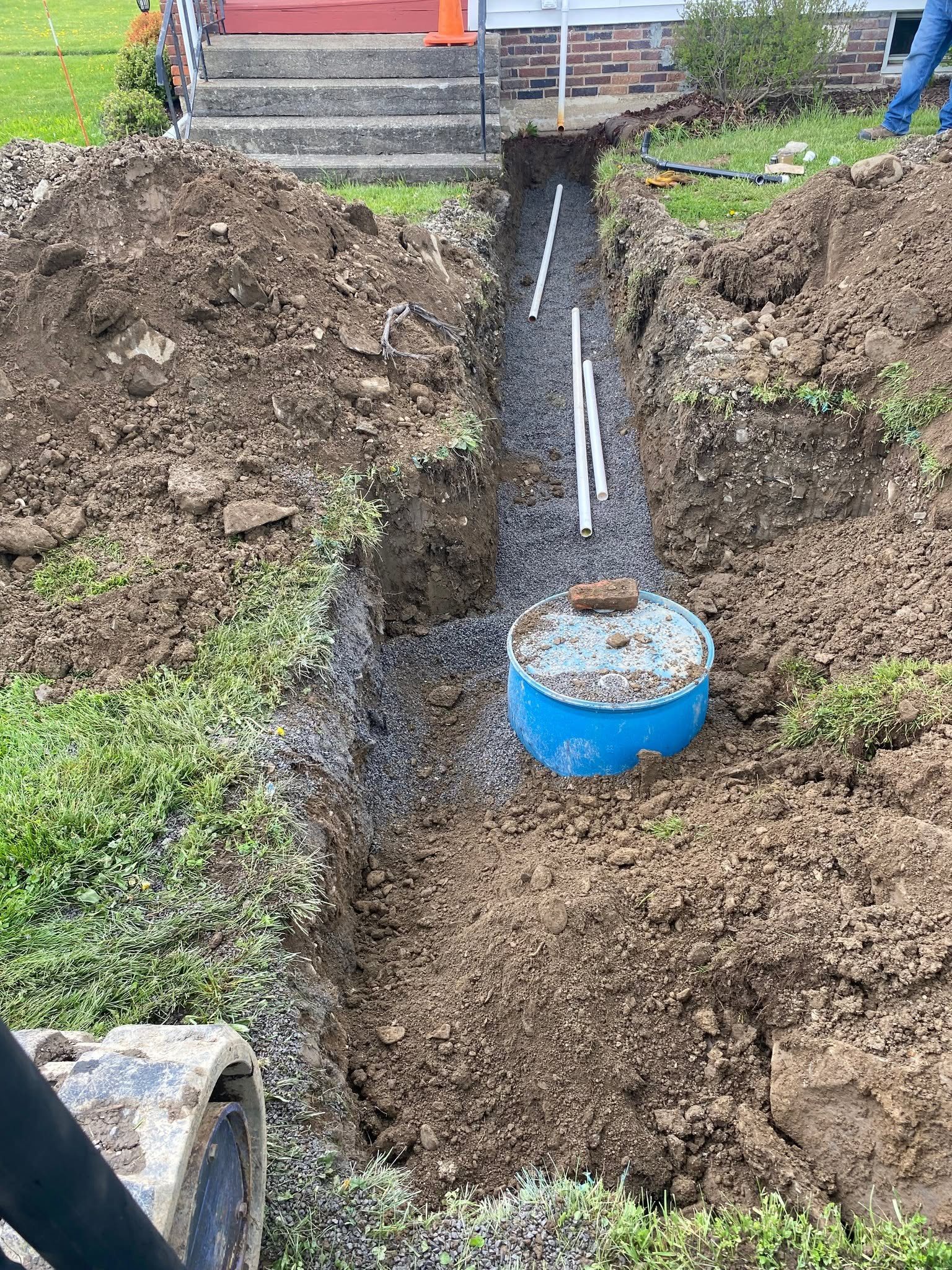 Trench and dry well installed for a basement sump pump