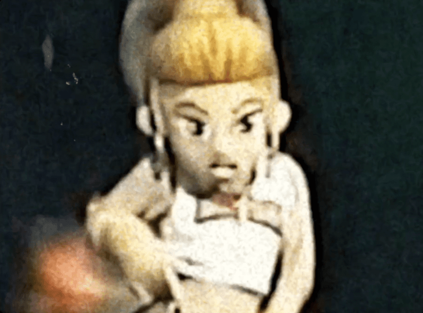 Dancer in black outfit with one leg raised behind