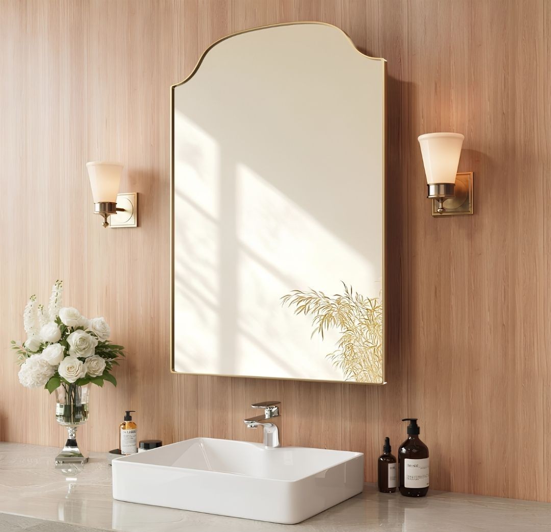 Arched medicine cabinet in bathroom with sconces
