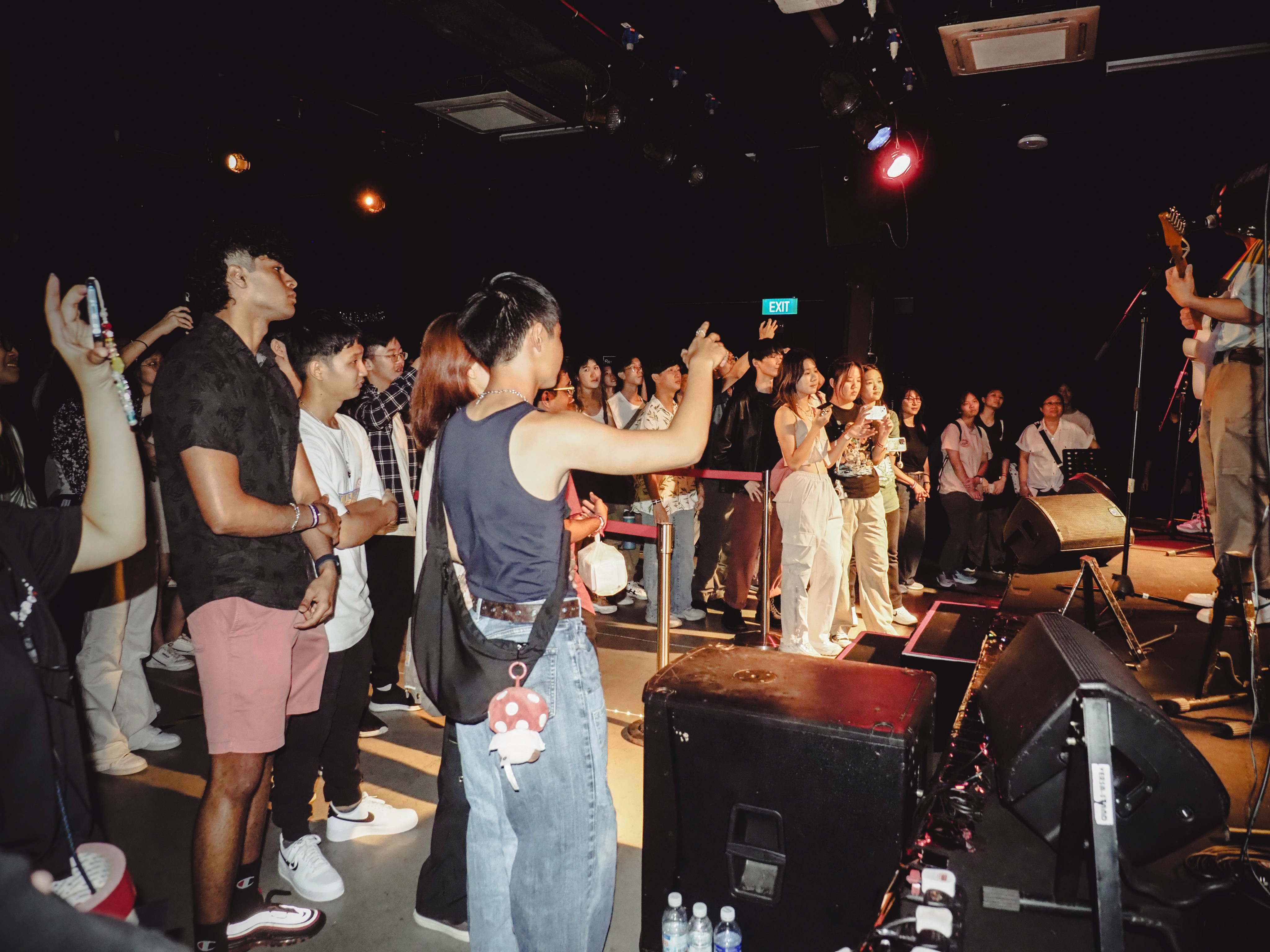 A behind-the-scenes photo of RE:surgence Vol 1, featuring the audience and some performers preparing to step on stage