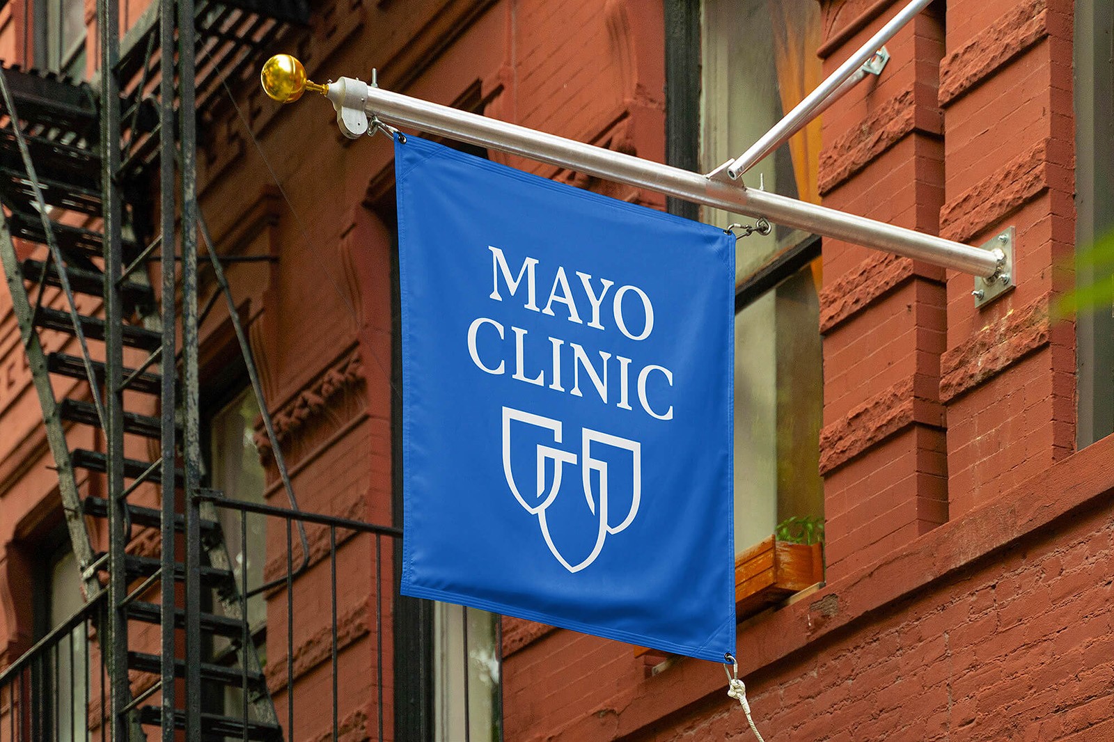 A blue banner with the text "Mayo Clinic" hanging from a building, showcasing the medical institution's logo.
