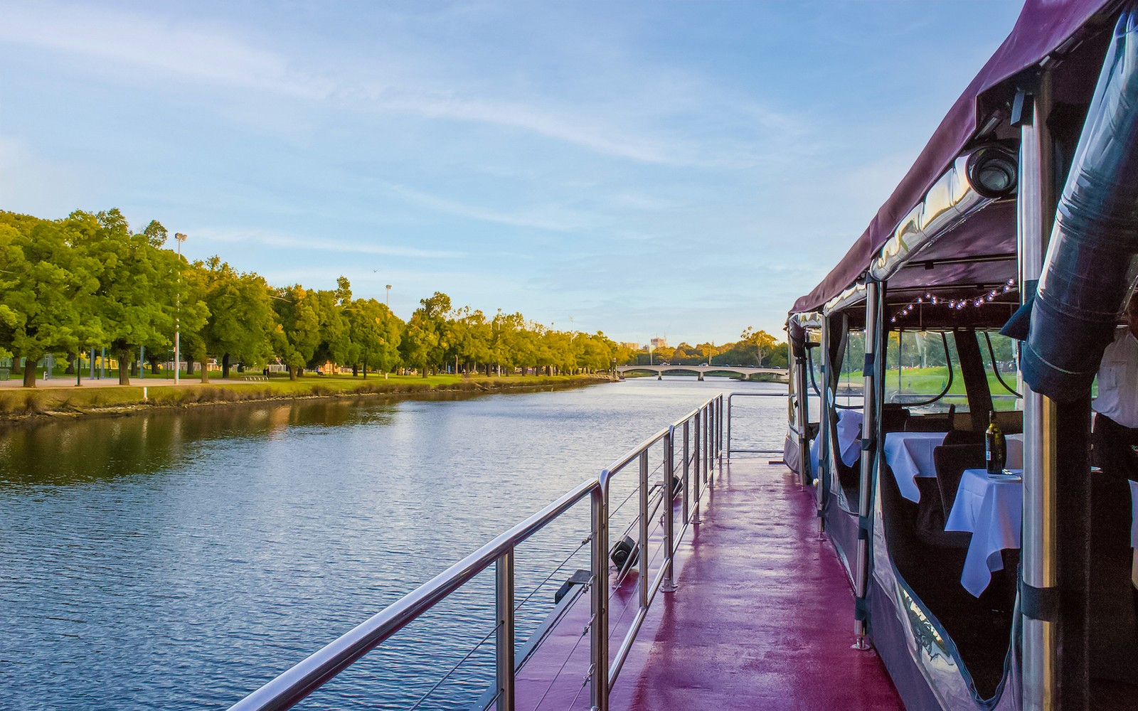 Cruise boat on Yarra River in Melbourne with tables set for brunch.