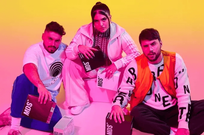 Snowy forest path with sun shining through trees