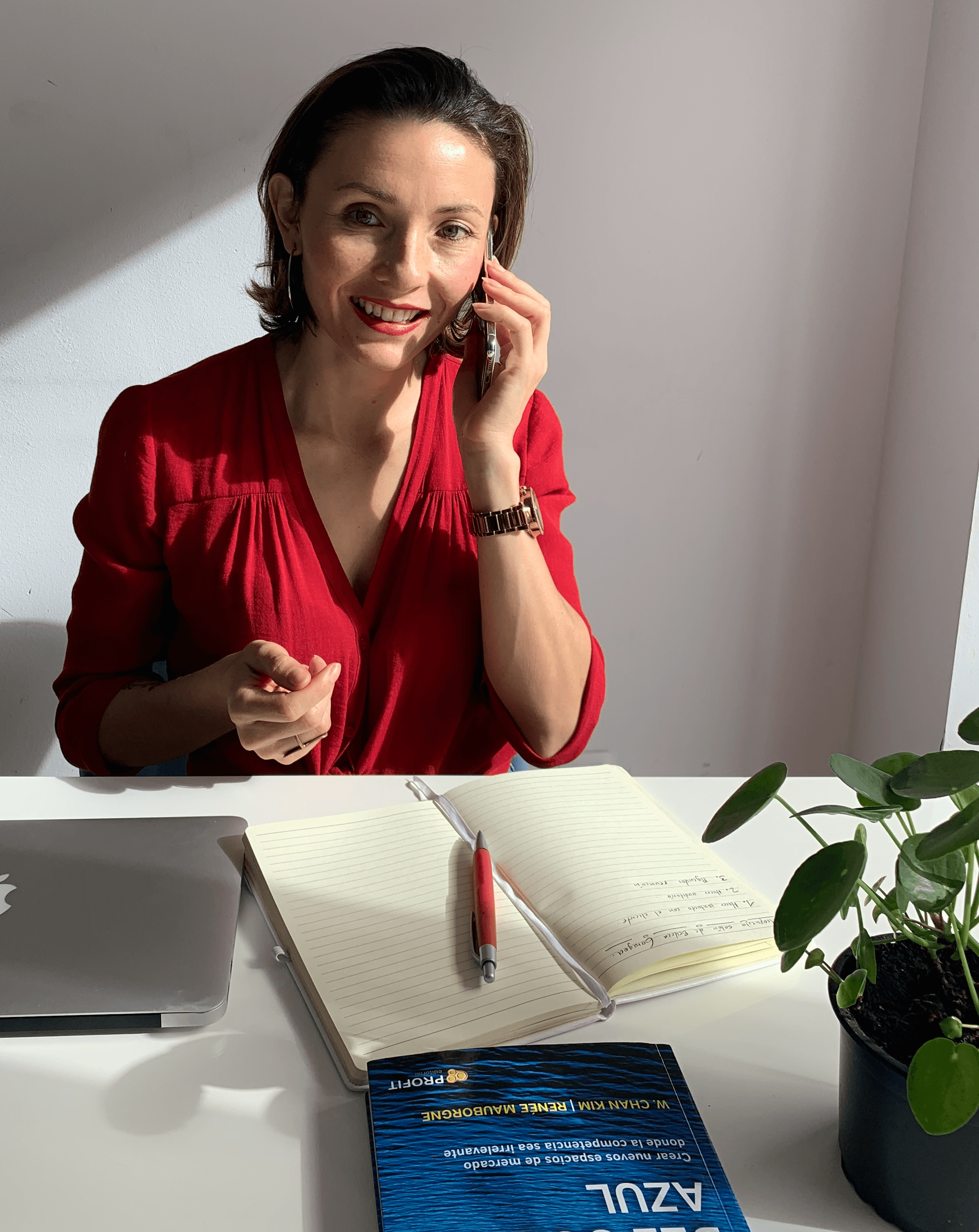 Thoughtful young man in a white shirt and glasses against a plain background.